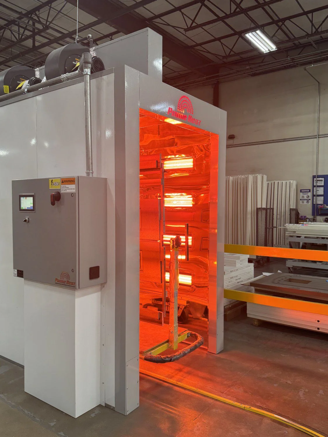 PRIME HEAT Halcon Tunnel Industrial machine a Revolutionary Finishing System that Maximize Halogen Technology and a control panel beside it.